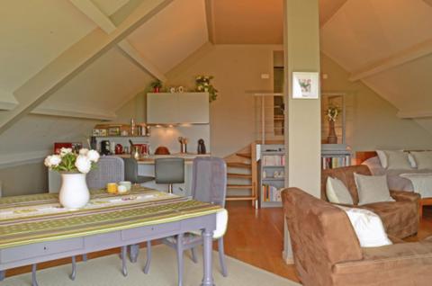 a kitchen and living room with a table and chairs at Un brin de Paradis "appartement de 100 m²" in Harzé