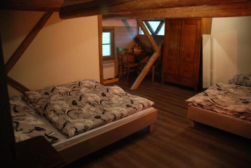 a bedroom with two beds and a stair case at Estate Marjetin dom in Idrija