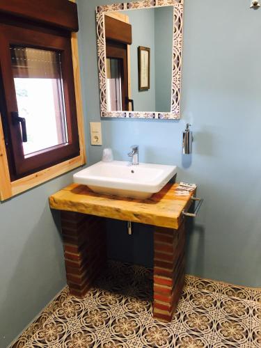 a bathroom with a sink and a mirror at Casa Susa in Poio