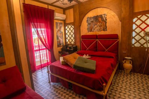 a bedroom with a red bed and a red bedspread at Nives Bed & Breakfast in Pompei