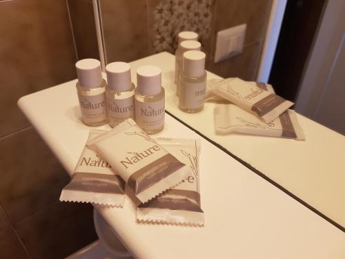 a bathroom counter with bottles of cosmetics on it at Residence La Meridiana in San Bartolomeo al Mare
