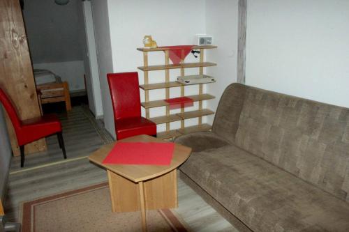 a living room with a couch and a table at Dworska Zagroda in Korytowo