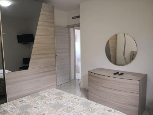 a bathroom with a vanity and a mirror in a room at Appartamento Belvedere Sassos P 3267 in Tresnuraghes