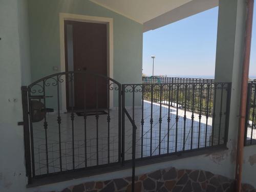 a balcony with a gate with a view of a fence at Appartamento Belvedere Sassos P 3267 in Tresnuraghes