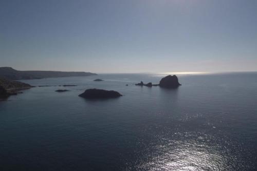 a large body of water with rocks in it at Appartamento Belvedere Sassos P 3267 in Tresnuraghes