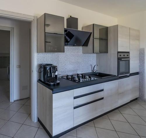 a kitchen with a sink and a stove top oven at Appartamento Belvedere Sassos P 3267 in Tresnuraghes