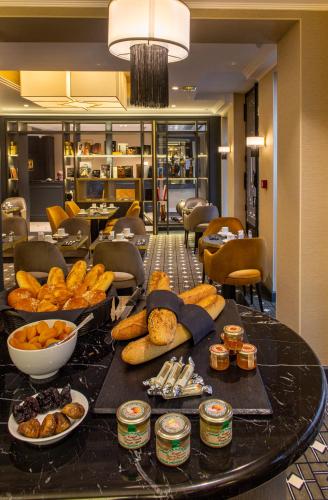 a table with a bunch of food on it at Lenox Montparnasse in Paris