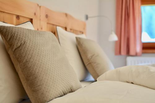 a pile of pillows sitting on a bed with at Berghof Niederthai in Niederthai