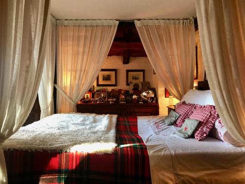a bedroom with a bed with curtains on it at Casa Sestrieres Chalet Vialattea in Sauze di Cesana