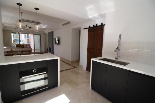 a kitchen with a sink and a counter top at Sotogrande - SotoLUX in Sotogrande
