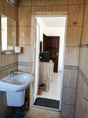 a bathroom with a toilet and a sink at Guestrooms Stoyanovi in Chernomorets