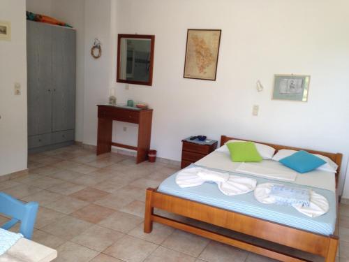 a bedroom with a bed and a table in a room at Villa Costa Studios in Vathi, Sifnos