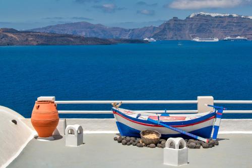 a boat sitting on the side of a cruise ship at Kokkinos Villas in Akrotiri