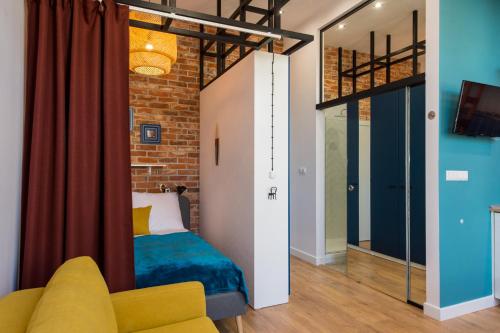 a bedroom with a bed and a couch in a room at Bliss Apartments in Poznań