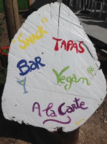 a sign on a tree with writing on it at Auberge de l'Arc en Ciel in Fauquembergues