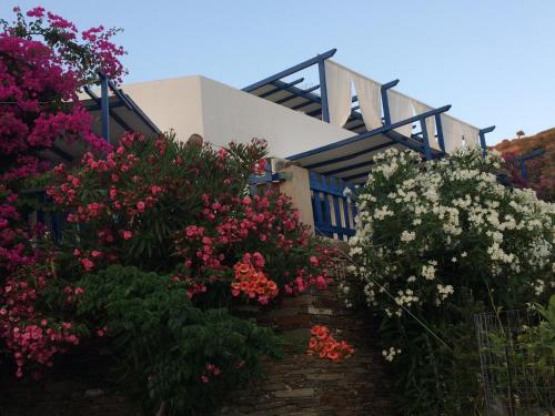 a house with colorful flowers in front of it at Villa Costa Studios in Vathi, Sifnos