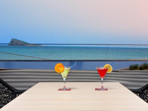 two cocktails on a table with a view of the ocean at Hotel Villa del Mar in Benidorm