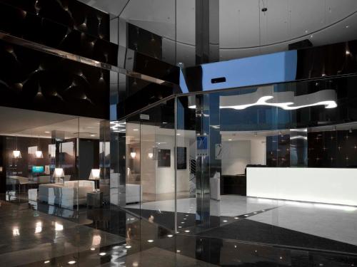 a lobby of a building with a glass wall at Hotel Villa del Mar in Benidorm
