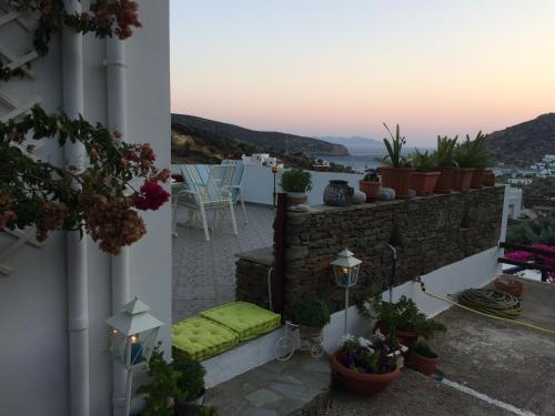 a balcony with a green seat on a building at Villa Costa Studios in Vathi, Sifnos