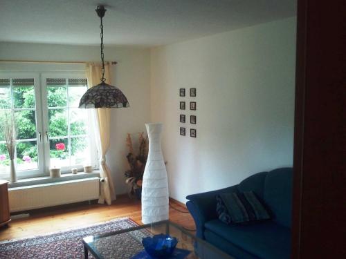 a living room with a blue couch and a window at Ferienhaus Juhnke in Kamminke