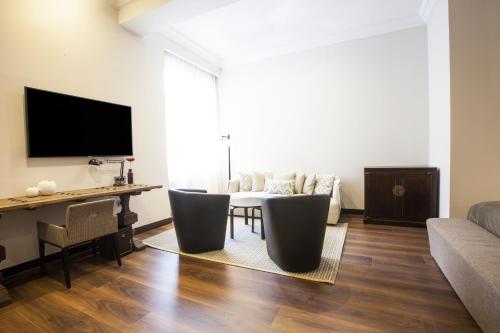 a living room with a couch and a table at Quentin Prague Hotel in Prague