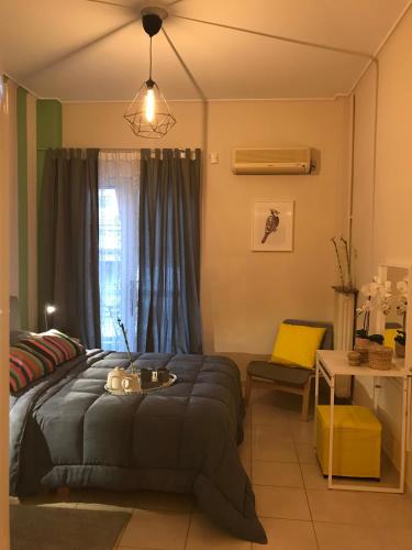 a bedroom with a bed and a table in it at Socrates path in Athens