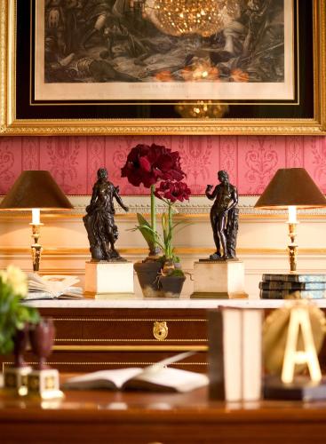 a table with two statues on top of it at Brugsche Suites - Luxury Guesthouse in Bruges