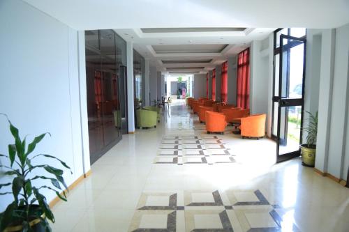 an empty corridor in a building with orange chairs at Haile Resort-Gondar in Gonder