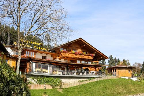 a large wooden house with a large balcony at Gasthof Pension Perauer in Lieserhofen