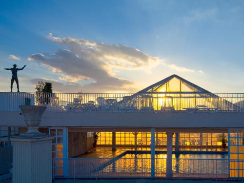a man standing on a bridge in front of a building at Magic Cristal Park in Benidorm