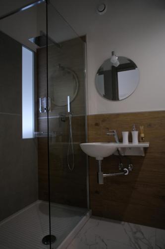 a bathroom with a shower and a sink and a mirror at PVrooms in Campobasso