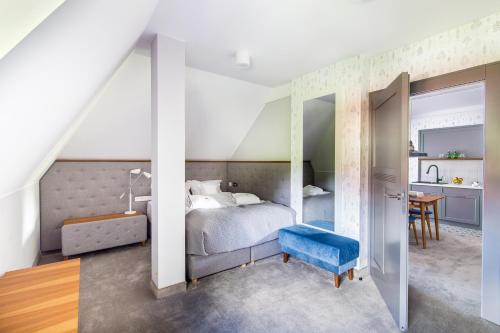 a bedroom with a bed and a table and a desk at Villa Testa in Sopot