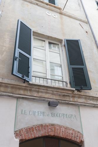 a building with two windows and a balcony at Le Camere Di Boccanegra in Sarzana