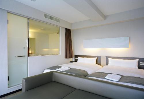 Voodi või voodid majutusasutuse Hotel Inside Numazu Inter toas