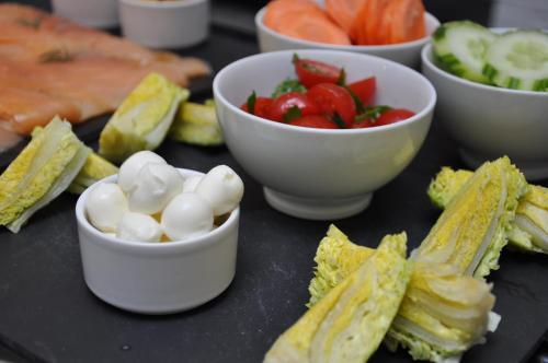 a black table with bowls of vegetables and dip at Le A in Paris