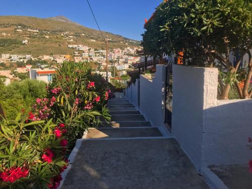 a stairway with flowers on the side of a building at Danaides Studios in Batsi