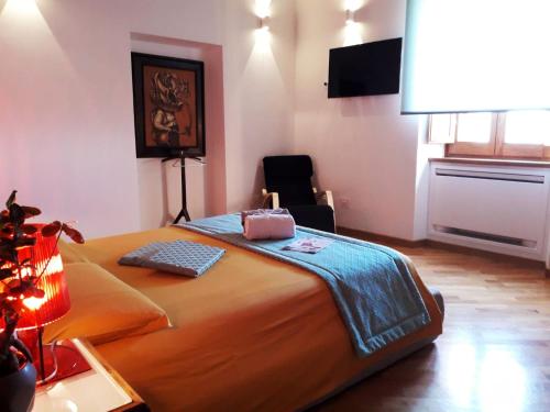a bedroom with a large orange bed and a desk at Palazzo Tronconi agriturismo in Arce