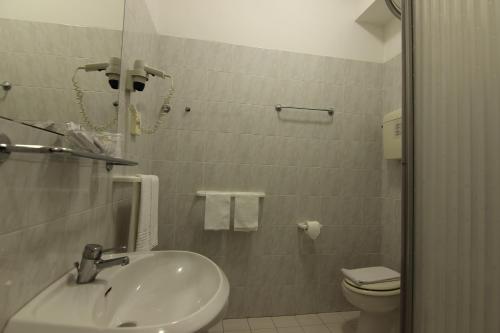 a bathroom with a sink and a toilet at Grand Hotel Excelsior in Senigallia