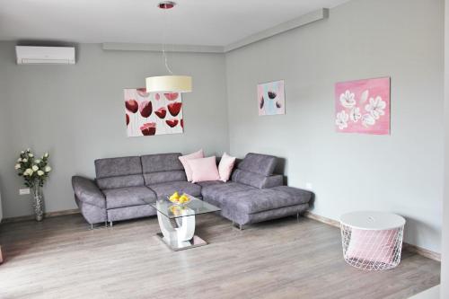 a living room with a couch and a table at Apartmani Žužić in Poreč