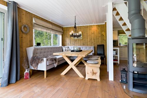 a living room with a table and a couch at Riverside in Hornindal