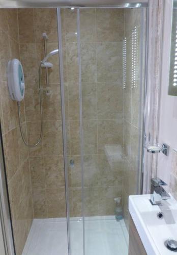 a shower with a glass door in a bathroom at Shepherds Rest in Kegworth