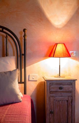a bedroom with a bed and a lamp on a night stand at Due Esperienza Panoramica in Lamezia Terme