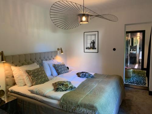 a bedroom with a large bed with two pillows on it at Hesselby Slott in Stockholm