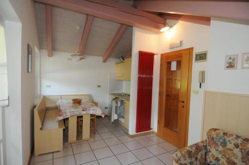 a small kitchen with a table in a room at Casa El Tobià in Pozza di Fassa