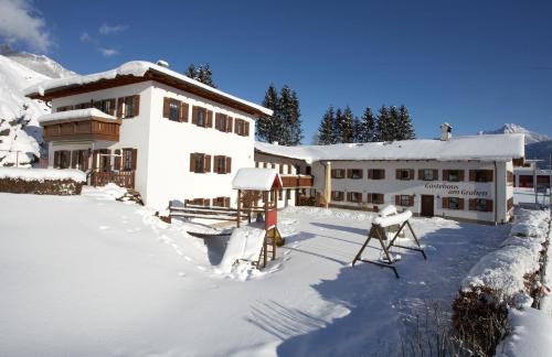 a large building with snow on the ground at Gästehaus am Graben in Reutte