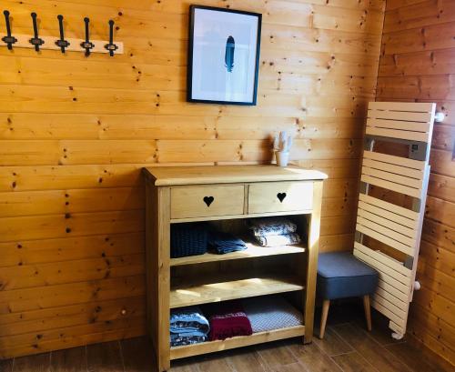 a wooden room with a desk and a chair at Le Hygge Chalet Gérardmer-Spa in Anould