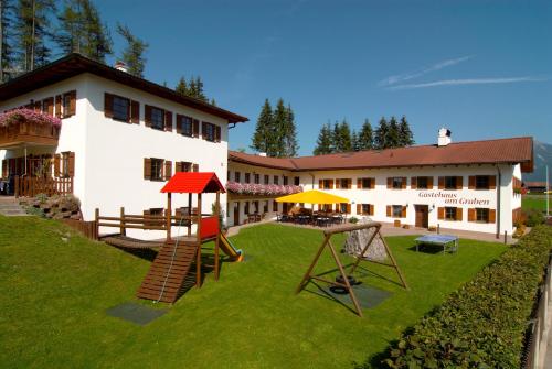 a house with a playground in front of it at Gästehaus am Graben in Reutte