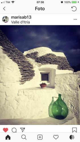 a picture of a building with a green vase at Borgo trulli 1789 in Ostuni
