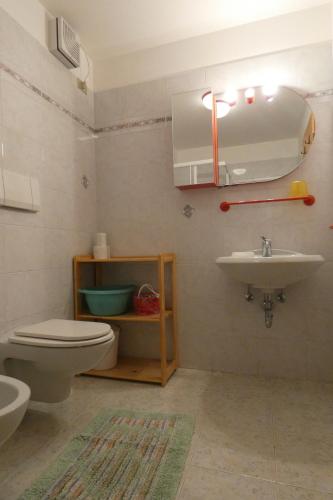 a bathroom with a toilet and a sink at Casa El Tobià in Pozza di Fassa