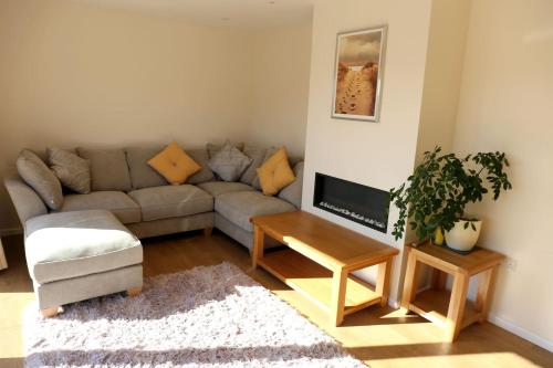 a living room with a couch and a table at Granby in Nailsworth